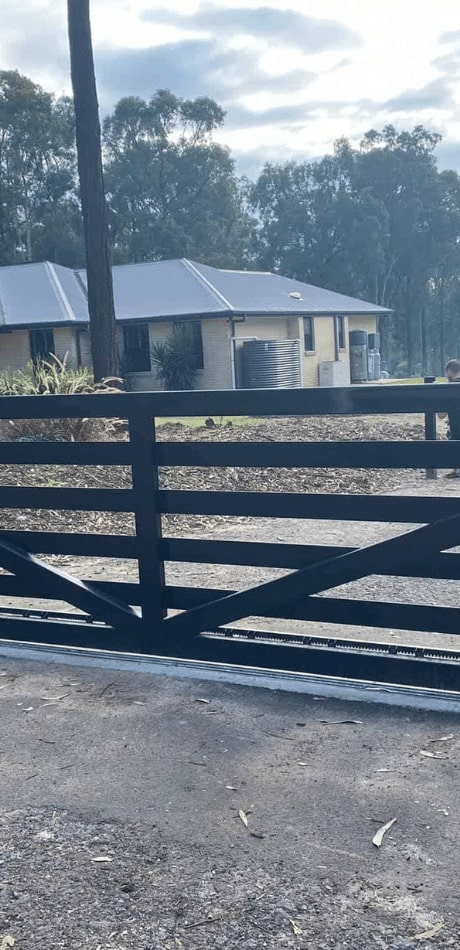 Wooden automatic gate in home driveway