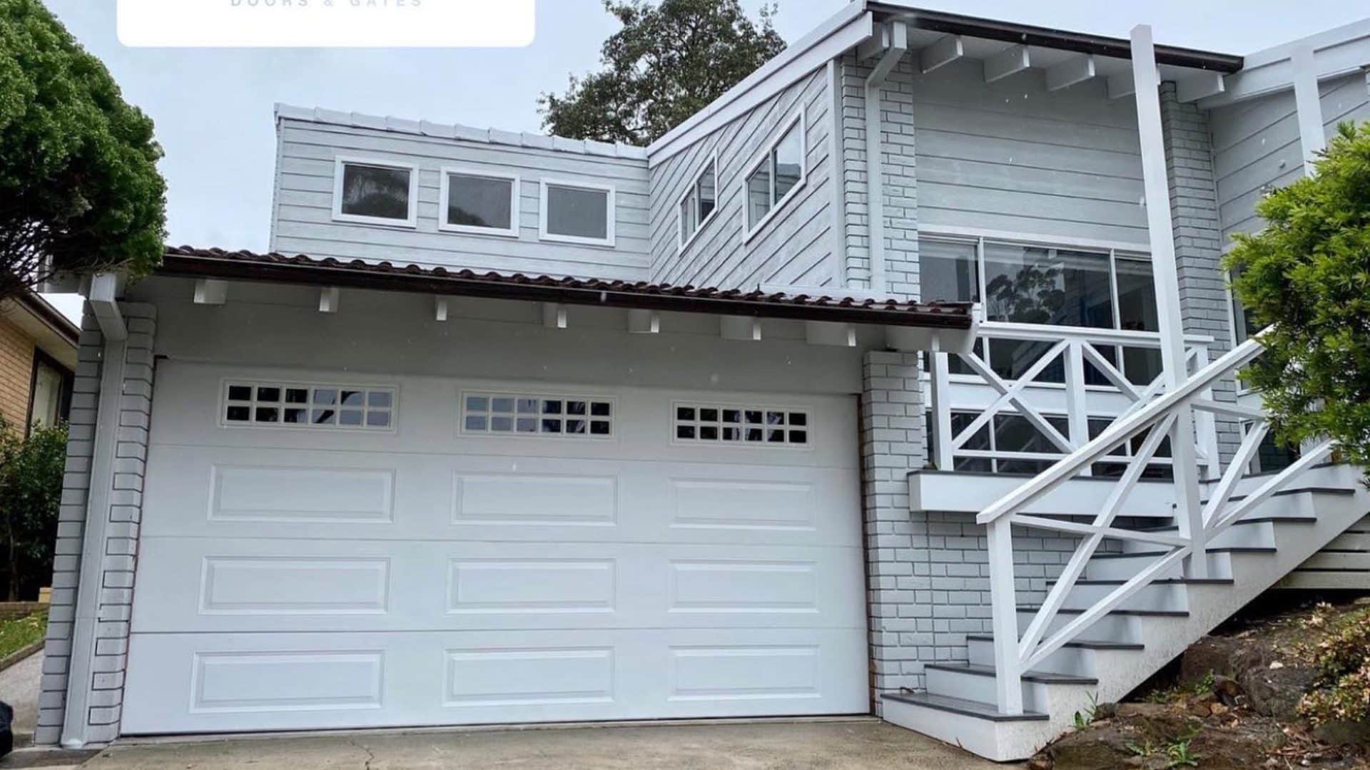 White panel lift garage door closed across a residential garage opening